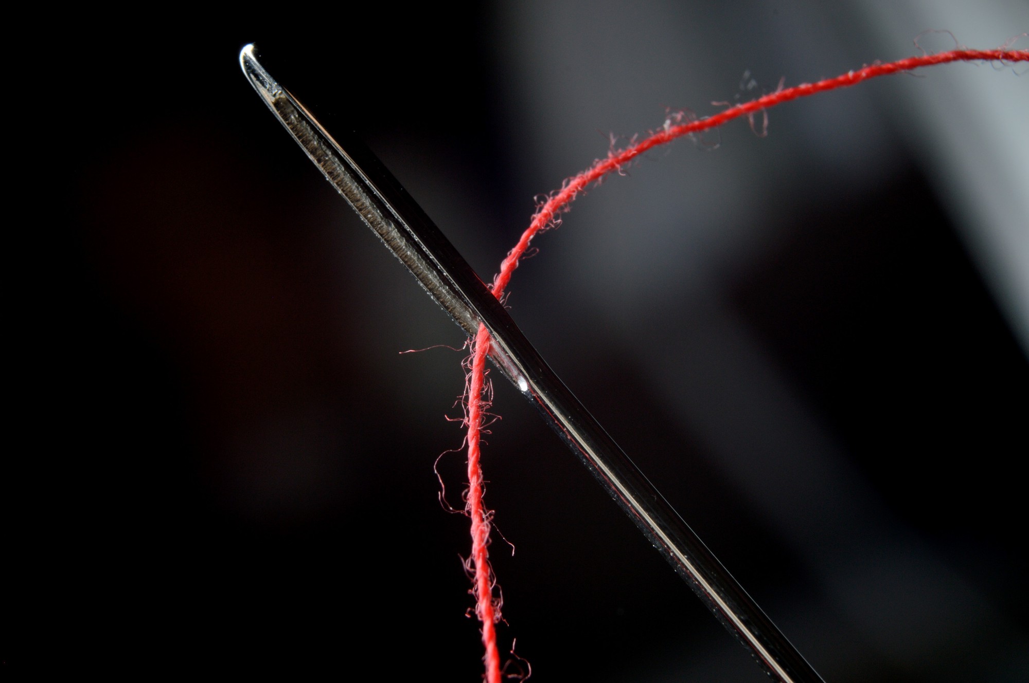 Macro of satin stitch gradient on black linen
